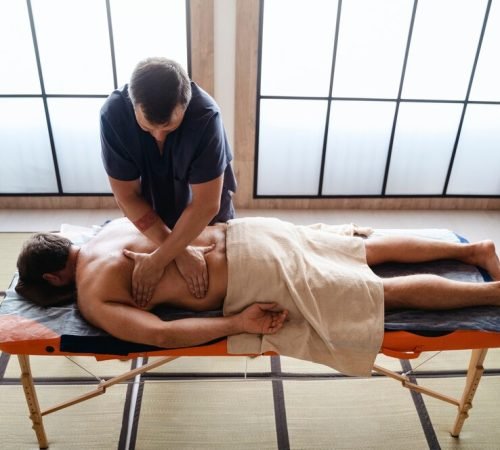 high-angle-man-getting-massage_23-2150649793