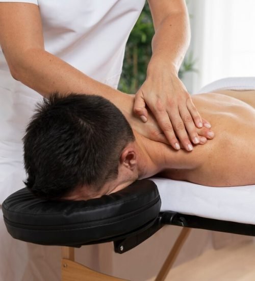 physiotherapist-massaging-patient-office_23-2149143816 (1)