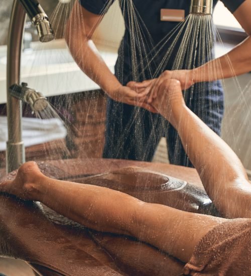 Portrait of doctor podiatrist does an examination and massage of the patient feet in the clinic